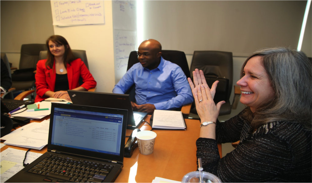 University of Michigan Ross School MBAs meet with one of their faculty advisors, Paula Caproni, at Miami Dolphins headquarters. Pictured students are Alexa Likens and C.J. Azubuine. They’re working on a Multidisciplinary Action Project, or MAP. The team of six designed a comprehensive learning and development program for the NFL team. Photo by Angel Valentin.