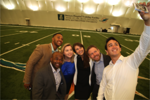 University of Michigan Ross MBA students take a selfie on the 50-yard line at the Miami Dolphins training facility in Davie, Fla.