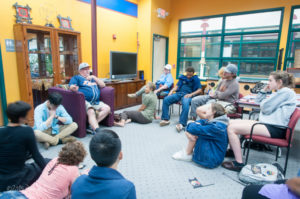 Through a course called Archives and Oral Histories, University of Michigan students learn firsthand the history and traditions of the Sault Saint Marie Chippewa Tribe. Here Tribal Elder Cecil Pavlat shares stories with the students during a visit to the Tribal Learning Center. Photo by John Diehl, U-M. 