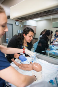 U-M Nursing students suction and clean the newborn during class in the Clinical Learning Center the U-M School of Nursing. Credit: Michigan Photography