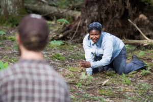 U-M wildlife ecologist Nyeema Harris conducts a “walk test” to verify that a motion-triggered camera is functioning properly.