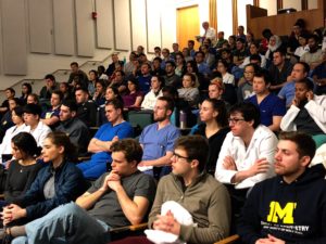 A crowd of dental students listen to classical music.