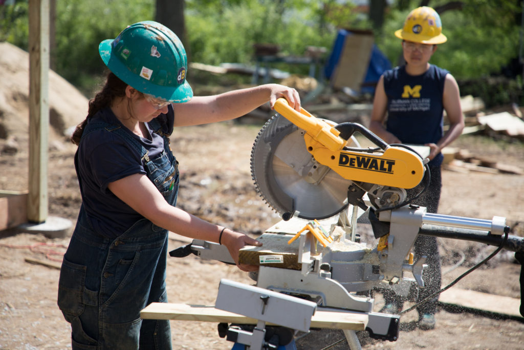 Female student operates a table circle saw