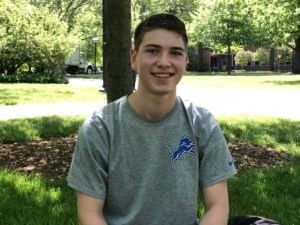 Young male student Marcus Cook picture in front of trees