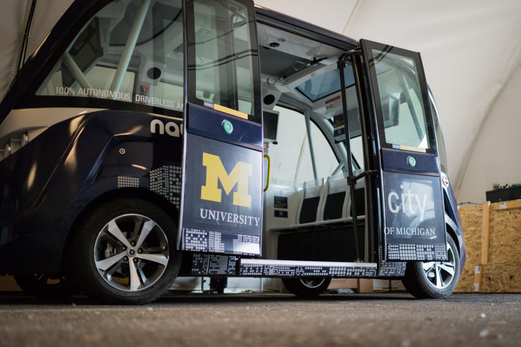 The shuttle stands with its doors open, ready to take passengers.