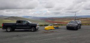 Several vehicles in the University of Michigan Solar Car Team's caravan. When it's on the road, Novum travels in a caravan behind the lead vehicle and in front of the chase vehicle. Photo by Rishabh Goel