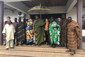 University of Michigan Provost Martin Philbert stands with community members wearing African garb.