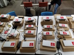 Rows of routers sit on a table, ready to be used.