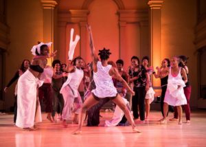 Large group of dancers mid-pose.