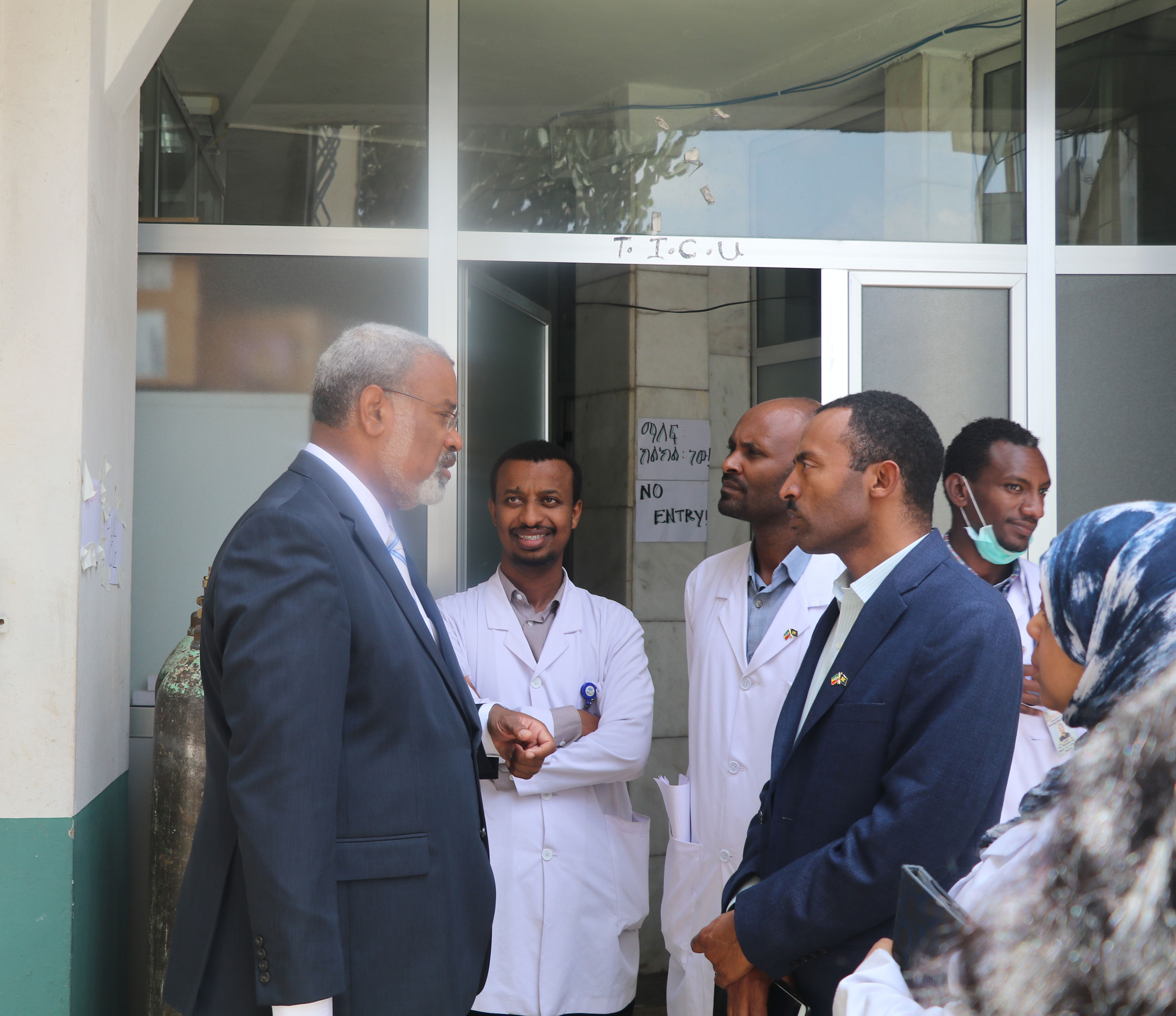 University of Michigan Provost Martin Philbert converses with doctors outside of a hospital in Africa.