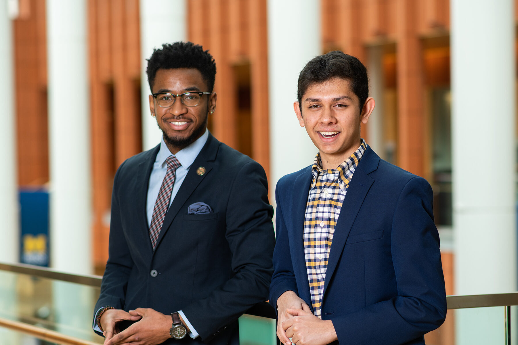 Two students smile in the UM Ross School of Business building.