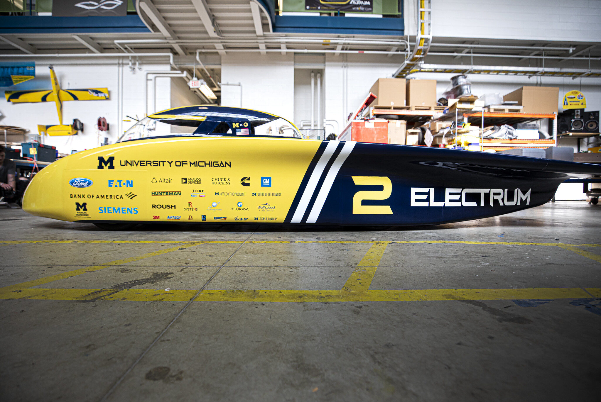 Large solar car parked in garage.